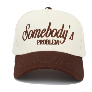 Close-up of Somebody's PROBLEM embroidery on two-tone trucker hat with premium stitching