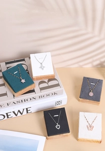 Macro view of multi-color velvet and wood jewelry pendant display stands for showcases
