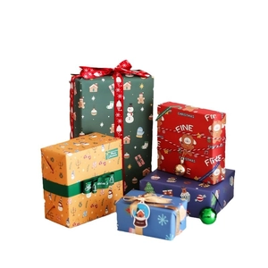 Festive Christmas gift wrapping paper and ribbons set with colorful boxes on white backdrop