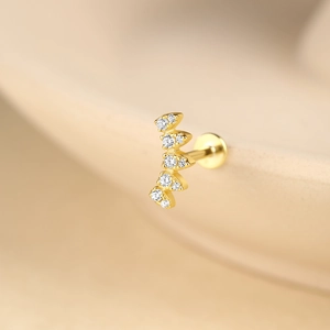 Vue macro de boucles d'oreilles incurvées en argent S925 doré avec pampilles en zircon