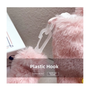 Detail of transparent plastic hook and soft pink plush fabric on the kids handbag
