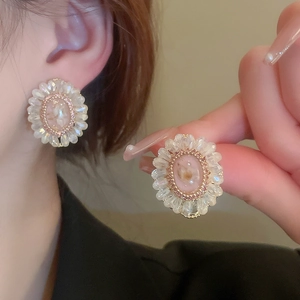 Elegant floral stud earrings featuring pink crystal petals and vintage gold detailing