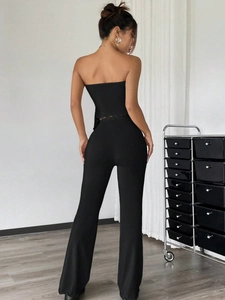 Rear view of sleek black two-piece set featuring a tube top and flared trousers