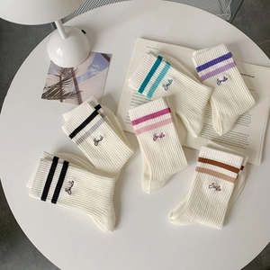 Detailed texture of ribbed cotton sports socks with multi-color stripes and Smile embroidery