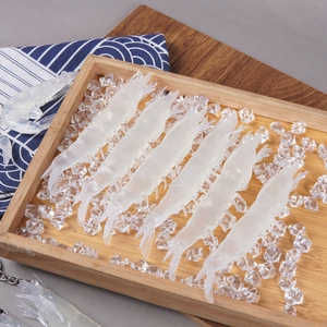 Realistic PVC shrimp food models with faux ice cubes on a wooden plate for decoration