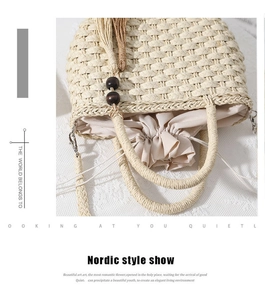 Close-up of straw woven bag with wooden beads tassels and secure drawstring lining