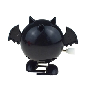Detail showing the mechanical wind-up mechanism on a black Halloween bat clockwork toy