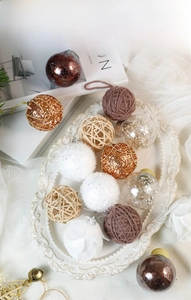 Detail of Christmas ornament set with glitter, snowballs, and vine balls on an elegant tray