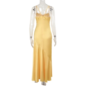 Detail of lemon yellow satin dress showing slim straps, hidden back zipper and silk texture