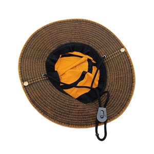 Detail view of woven outdoor sun hat featuring orange lining and mesh ventilation band