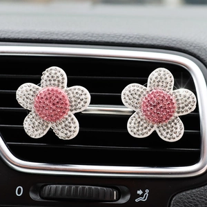 Sparkling crystal flower car air vent clips with pink and white rhinestones in car interior