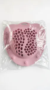 Pink heart-shaped silicone laundry bag with paw print cutout detail in plastic packaging