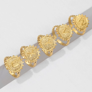 Detail showing gold vintage letter rings with embossed U, X, Y, V, W alphabet designs