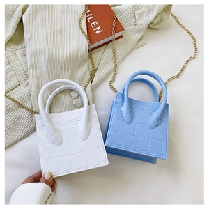 Mini handbags with crocodile pattern in white and blue featuring golden chain straps