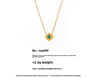 Close-up of 18k gold-plated sunflower pendant with natural gemstone on titanium chain