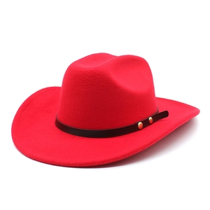 Detail of red wool felt cowboy hat with leather band and gold metal rivet accents