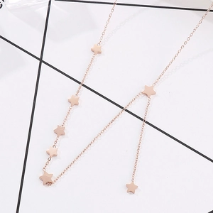 Detailed view of rose gold Y-shaped necklace with multiple five-pointed star pendants