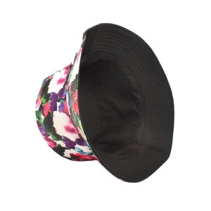 Reversible tie-dye bucket hat showing colorful floral print and solid black inner lining