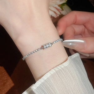 Detail of silver tennis bracelet with dense zircon inlay and cylindrical pavé clasp
