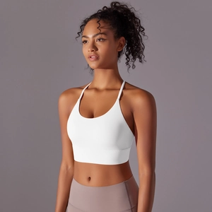 Close-up of white racerback sports bra with cross straps and wide elastic underband
