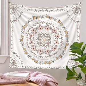 Detail of bohemian mandala tapestry featuring pink floral patterns on off-white fabric