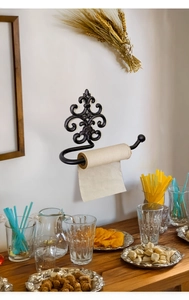 Vintage black cast iron wall-mounted paper towel holder with ornate floral scrollwork
