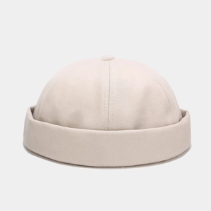 Detail view of cotton docker cap stitching and button on the beige crown