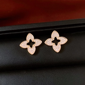 Macro shot of 18K gold plated flower earrings with cubic zirconia and star cutout