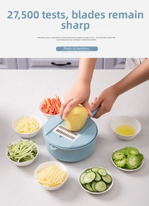 Detail of blue vegetable slicer with stainless steel blades and food container