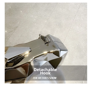 Detail of detachable metal hook on the silver geometric mirrored acrylic clutch bag
