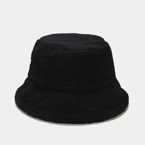 Close-up of black fuzzy lamb wool bucket hat texture with thick thermal fleece material