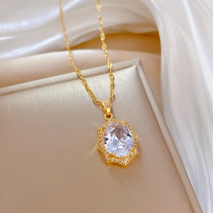 Elegant gold necklace with oval diamond-cut zircon pendant on premium silk background