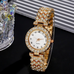 Macro shot of luxury gold quartz watch with diamond bezel and metallic chain link strap