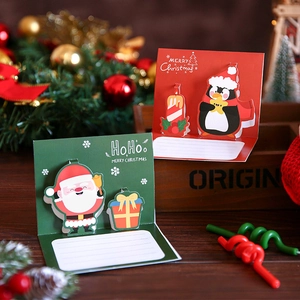 3D pop-up Christmas cards featuring Santa and penguin designs with festive gift box scenery