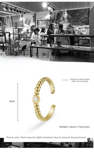 Detail of 14K gold plated stainless steel twisted ring set with a clear zircon stone