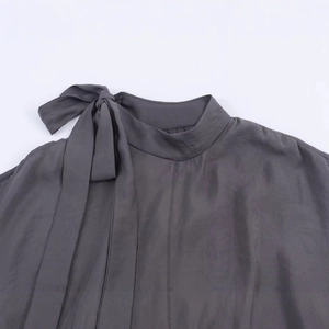 Women's dark grey high-neck blouse featuring open shoulder details and bow-tie neckline