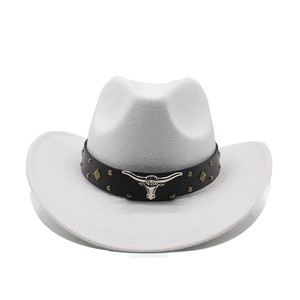 Detailed view of white felt cowboy hat with leather band and silver bull head emblem