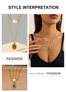 Detail of double-layer gold necklace featuring a white pearl and black oval gemstone pendant