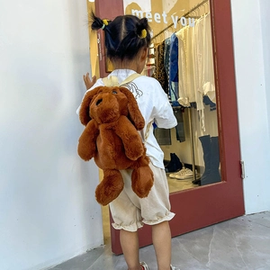 Cute brown plush dog backpack for kids with soft long fur and adjustable straps