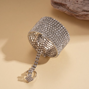 Close-up of silver multilayer rhinestone cuff bracelet connected to a matching ring
