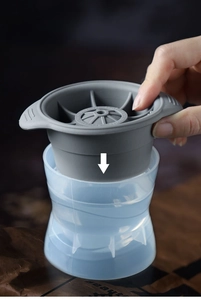 Detail showing the pressing mechanism of silicone spherical ice ball mold with blue base