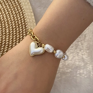 Golden stainless steel chain bracelet with heart pearl and irregular pearls on hand
