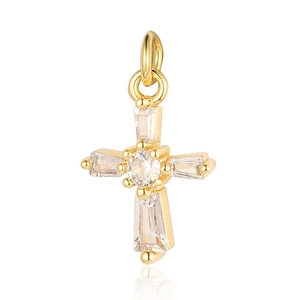 Close-up of golden cross pendant with crystal inlays and polished metal finish details