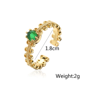 Detail view of gold geometric ring with green zircon showing 1.8cm inner diameter and 2g weight