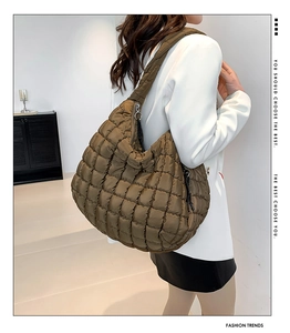 Brown quilted cloud tote bag shown on model for autumn fashion with spacious interior