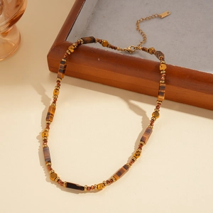 Detail of tiger eye stone beads and gold faceted metal accents on a vintage necklace