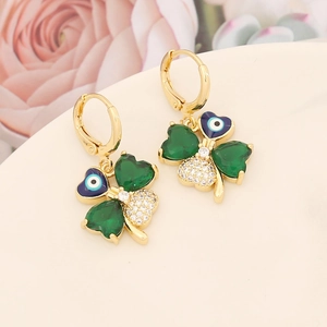 Detail of four-leaf clover earrings with green and blue stones and evil eye motif