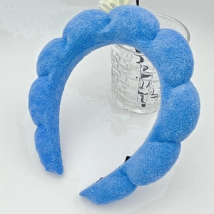 Detailed view of the sky blue sponge headband with soft plush terry cloth texture