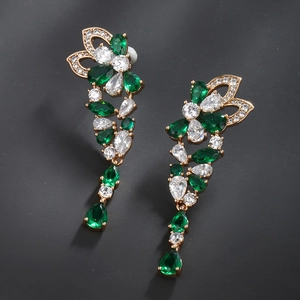 Detail of emerald green teardrop earrings with gold plating and cubic zirconia stones
