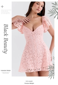 Detail of pink crochet lace dress featuring a deep V-neck and ruffled sleeve edges